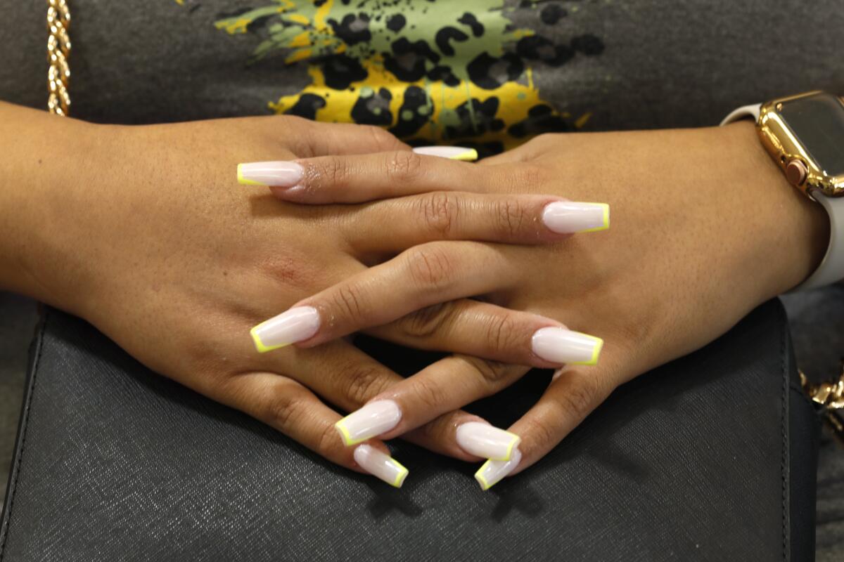 A customer at Captivate Nail & Spa in Fullerton shows off her nails after the salon reopened during the pandemic.