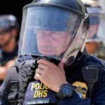 National Guard and DHS police stand guard outside the Metropolitan Detention Center, Wednesday, June 11, 2025, in Los Angeles. (AP Photo/Damian Dovarganes)