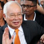 Former Malaysia PM discharged but not acquitted of money laundering charges