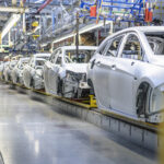 Car bodies on a factory assembly line.