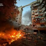 Rescuers working at the site of an airstrike on a residential area in Kyiv