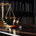 Judge's gavel on a table with scales